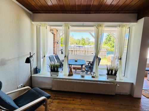 una sala de estar con una mesa en una ventana en Strandhaus Graalibu en Graal-Müritz