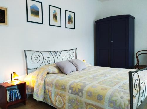 a bedroom with a bed with a colorful bedspread and a table at Apartment 'Angelo' in traditional stone house in Slime