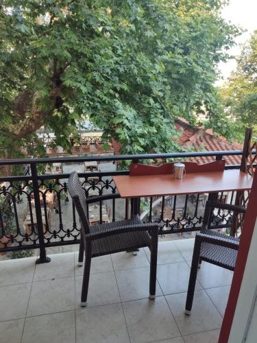 a table and two chairs on a balcony at Amaya Pine Studio in Panayia