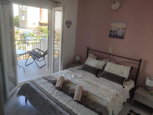 1 dormitorio con 1 cama y balcón en Bee life apts, Sweet house en Kókkinos Pírgos