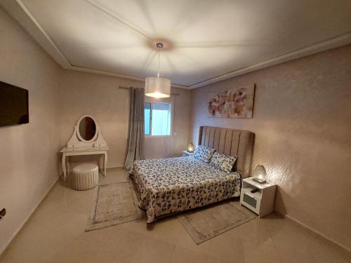 a small bedroom with a bed and a window at Appartement kenitra mall in Kenitra