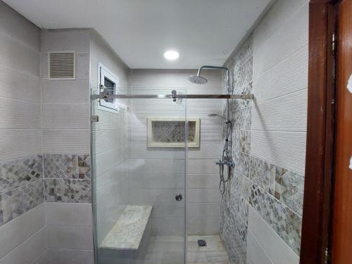 a bathroom with a shower with a glass door at Appartement kenitra mall in Kenitra