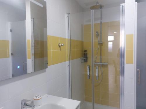 a bathroom with a shower and a sink and a mirror at La Palma in Tarajalejo