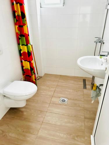 a bathroom with a toilet and a sink at Apartmani Neo in Sutomore