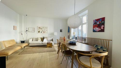 a living room with a table and a couch at ApartmentInCopenhagen Apartment 1543 in Copenhagen