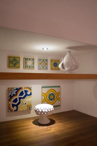 a table in a room with paintings on the wall at B-Welcome Rooms of Charme e Relax in Polignano a Mare