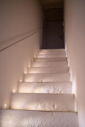 a stairway with white stairs with lights on it at B-Welcome Rooms of Charme e Relax in Polignano a Mare
