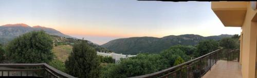 a balcony with a view of a river and mountains at VILLA APHRODITE SOUGIA apt1 in Kamária