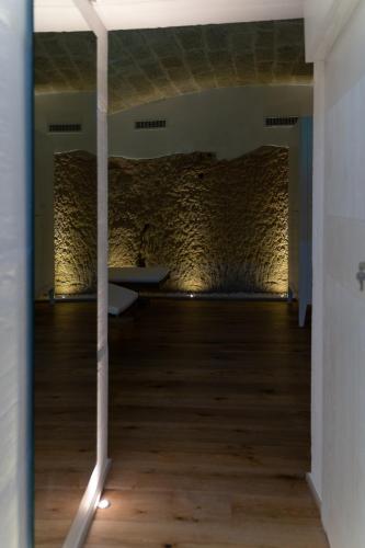 a room with a bed and a wooden floor at B-Welcome Rooms of Charme e Relax in Polignano a Mare