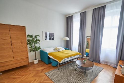 a bedroom with a bed and a table at Renovated & Cozy - Close to Museumsquartier in Vienna