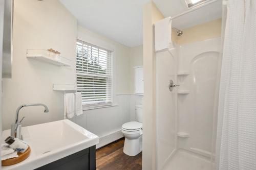 a white bathroom with a sink and a toilet at The Inn & More in Bartlett