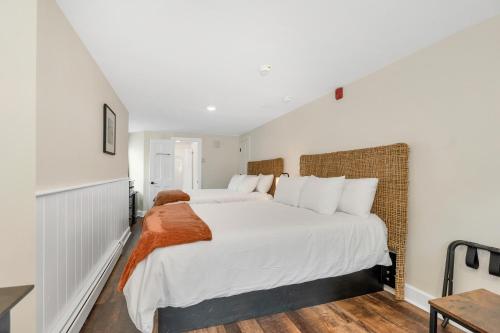 a white bedroom with a large bed with white pillows at The Inn & More in Bartlett