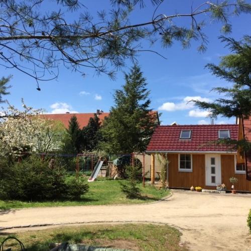 a house with a red roof and a driveway at Ferienwohnung Niesky in Niesky