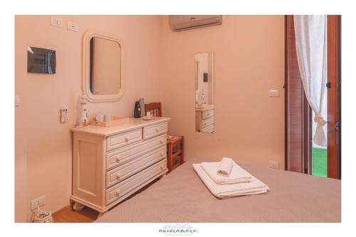 a bathroom with a white dresser and a mirror at Ancóramare in Stintino