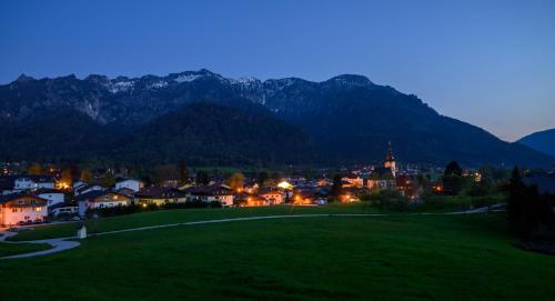 a small town at night with mountains in the background at Am Randersberg - Wohnung Nr 4 in Grossgmain