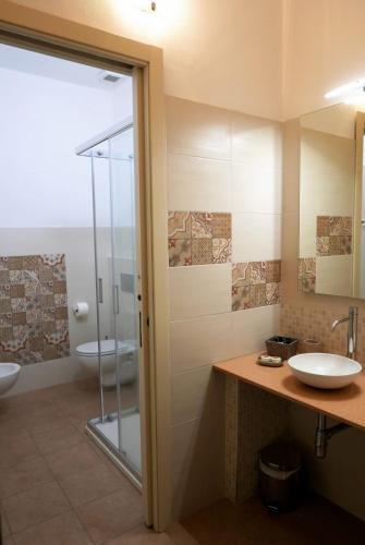 a bathroom with a glass shower and a sink at La Torretta in Piombino