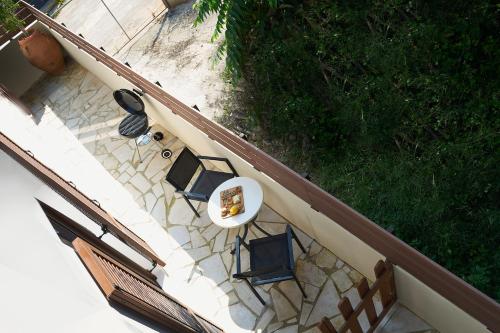 an overhead view of a table and chairs on a patio at 2 bedroom Villa with heated swimming pool-Spa whirlpool-BBQ! in Melidhónion