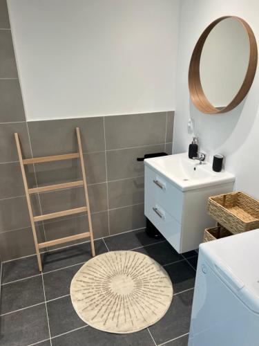 a bathroom with a sink and a mirror at CreamHouse in Międzyzdroje