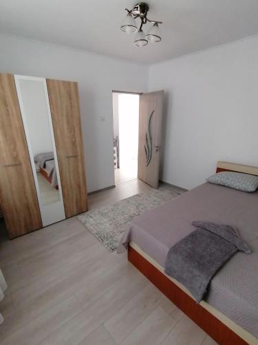 a bedroom with a bed and a large mirror at Concordia Apartament in Brăila