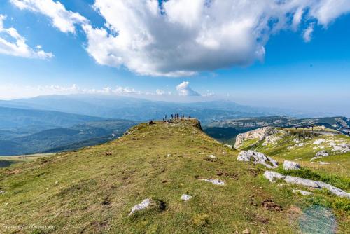 a group of people standing on top of a mountain at Gran Sasso in Prati di Tivo