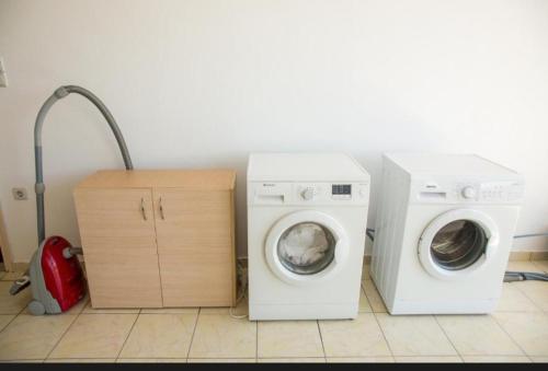 a laundry room with a washer and a washing machine at SPN.SPIROS APARTMENTS PREVEZA in Preveza