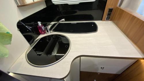 a bathroom counter with a sink and a mirror at Camper in Sandnes