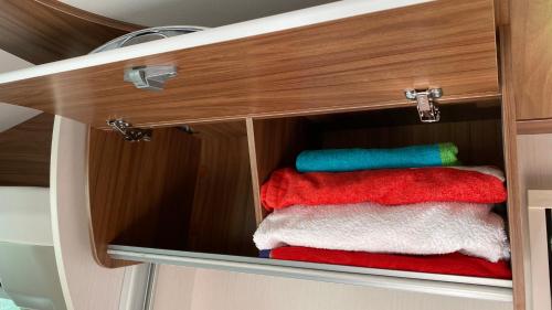 a cabinet with three towels in it at Camper in Sandnes