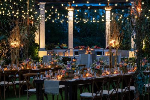 a table set up for a wedding with lights and candles at The Ritz-Carlton, Grand Cayman in George Town