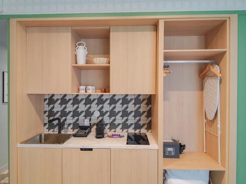 a kitchen with a sink and a counter top at Aparthotel AMMI Nice Lafayette in Nice