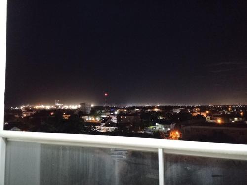 a view of a city at night from a balcony at Simply the most comfortable place next to Boca Chica beach in Boca Chica