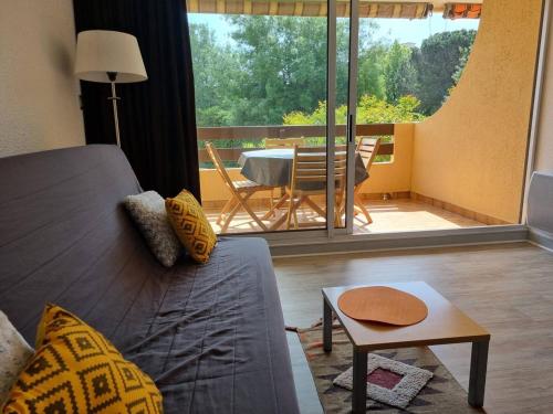 un salon avec un canapé et une table dans l'établissement Appartement T2 avec Piscine et Parking, 4 couchages, proche plage à Argelès-sur-Mer - FR-1-388-2, à Argelès-sur-Mer