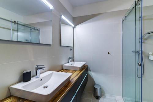 a bathroom with a sink and a glass shower at Villa Panorama in Senj