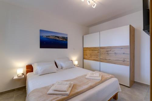 a bedroom with a large bed with two towels on it at Villa Panorama in Senj