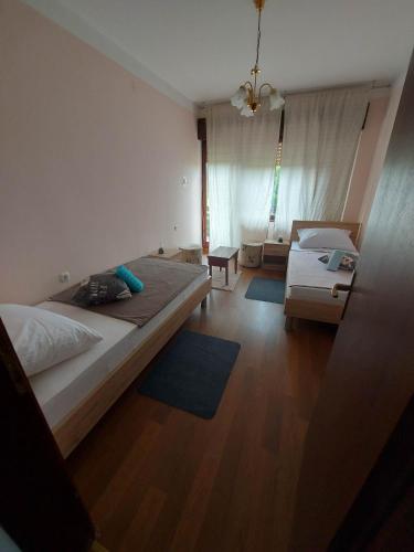 a large bedroom with two beds and a couch at Apartman Danny in Slunj