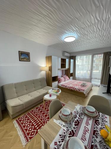 a living room with a couch and a table at Studio Shevitsa & free Garage in Veliko Tŭrnovo