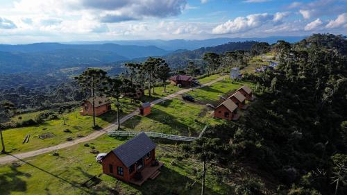 an aerial view of a village with houses and trees at Infinity Valley Cabanas in Urubici