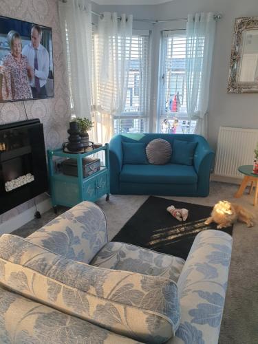 a living room with two couches and a tv at 2 bed lodge sleeps 6 in Rhyl