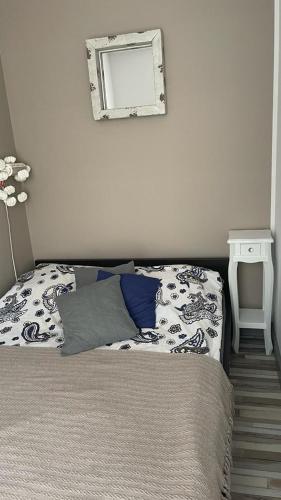 a bedroom with a bed and a mirror on the wall at Apartament Paula in Władysławowo