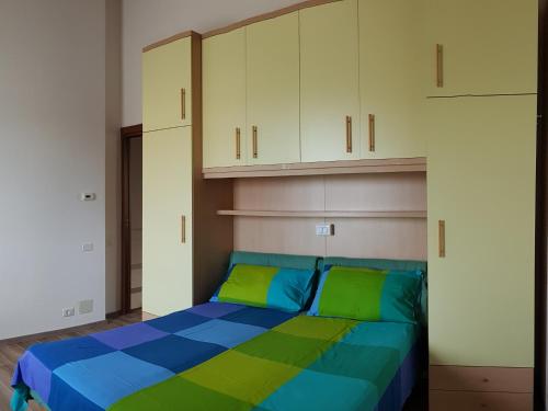 1 dormitorio con 1 cama de color verde y azul en La Maison de André, en Scaltenigo