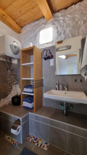 a bathroom with a sink and a mirror at House Agava in Veliko Grablje