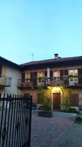 a house with a fence in front of it at La Vispa Ceresa in Castellinaldo