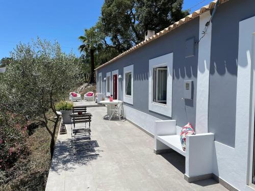 a patio with tables and chairs on a building at Monte Teu in São Luis