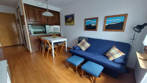 - un salon avec un canapé bleu et une table dans l'établissement CHECK IN CASAS Pirita, à Cerler