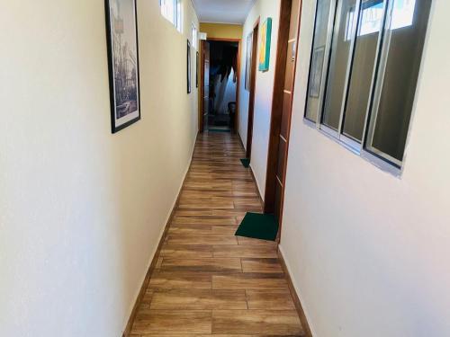 a hallway with a wooden floor in a building at Pousada Familia Aparecida in Aparecida