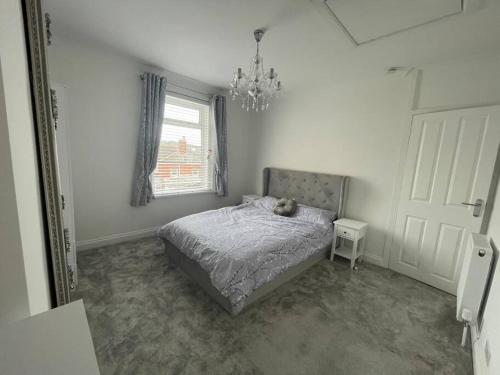 a bedroom with a bed with a teddy bear on it at Taylor’s Retreat in Radipole