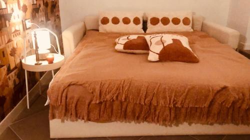 a bed with two pillows on it in a room at Casa ESTELLA in Magliolo