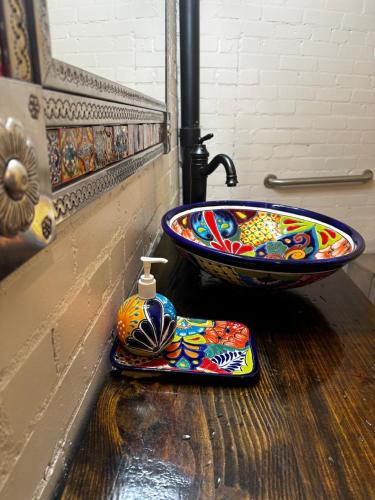 a bathroom with a sink and a counter top with a bowl at Dallas Farmers Market Area, Just right in Downtown in Dallas