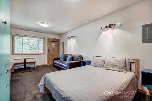 a bedroom with a bed and a couch and a desk at Completely Renovated Unit, Trendy Top Floor with Many Onsite Amenities PM7D in Breckenridge