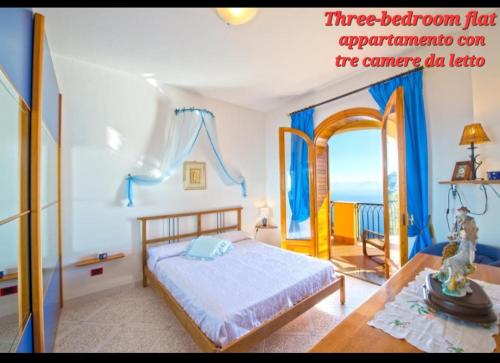 a bedroom with a bed and a table at Villa le Arcate in Furore