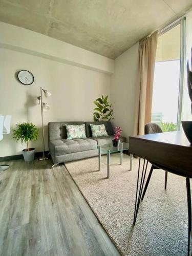 uma sala de estar com um sofá e uma mesa em Cozy & Modern - Near the Airport em San José